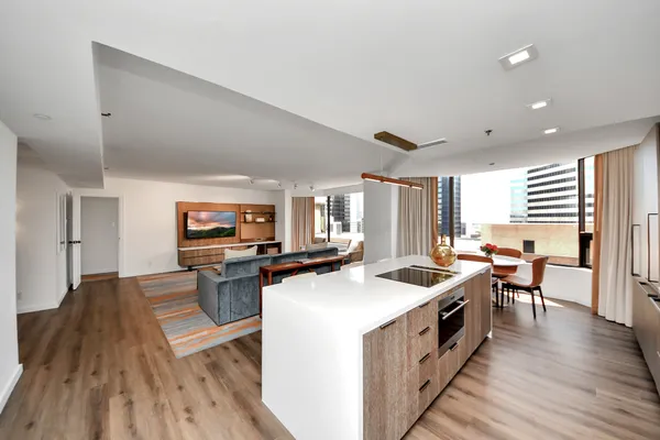a kitchen with stainless steel appliances a stove top oven and a refrigerator