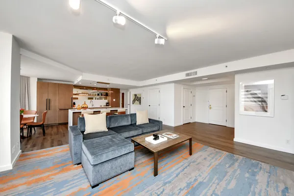 a living room with furniture and kitchen view