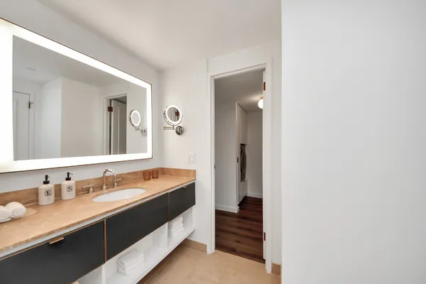 a bathroom with a granite countertop sink mirror and a
