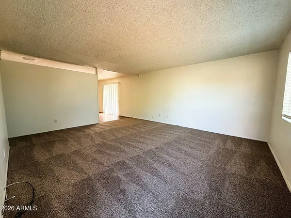 an empty room with a empty space and windows