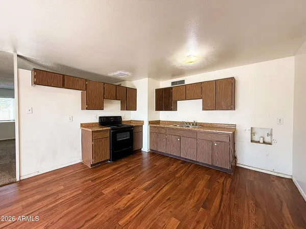 a kitchen with stainless steel appliances a refrigerator and a stove top oven