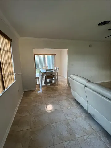 a view of kitchen with furniture and window