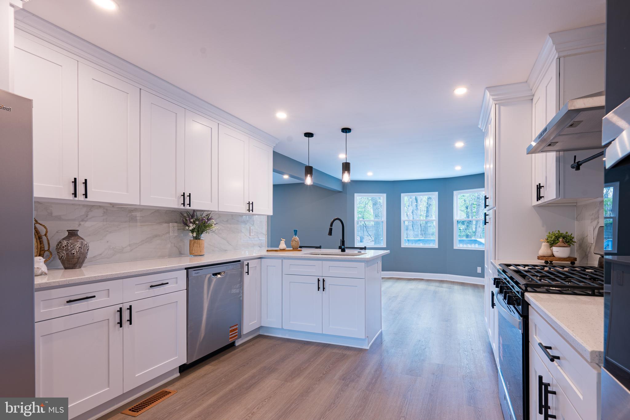 3 Slalom Court Pine Hill, NJ 08021 - Photo 5 of 47 a kitchen with white cabinets and wooden floor