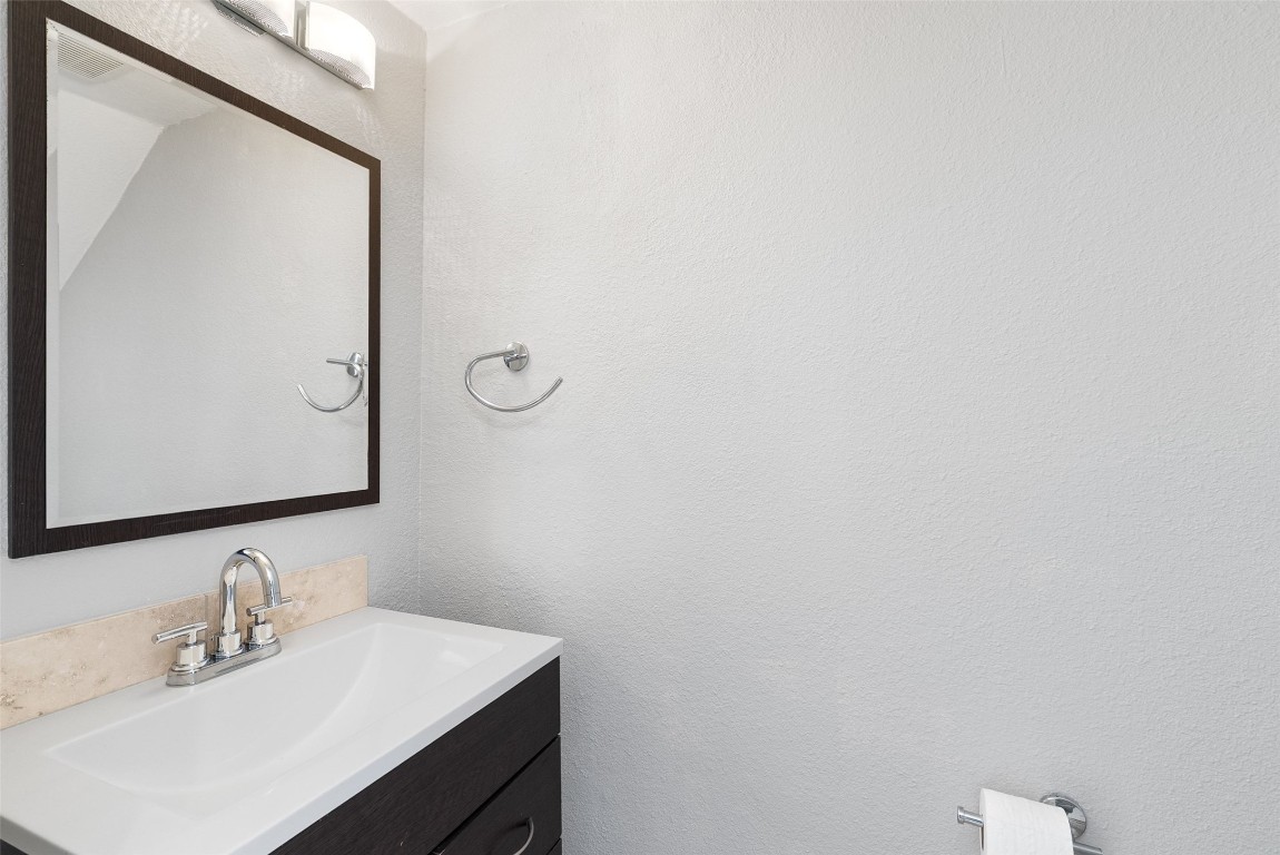 3601 Menchaca Road, Unit 117 Austin, TX 78704 - Photo 12 of 25 a bathroom with a sink and a mirror
