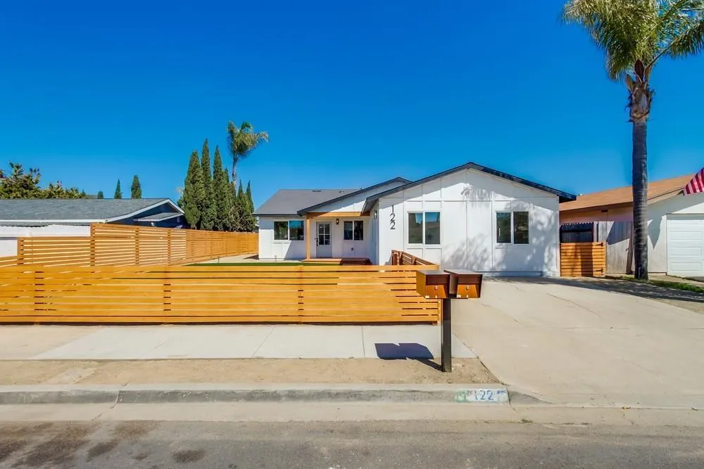 a view of a house with swimming pool and sitting area