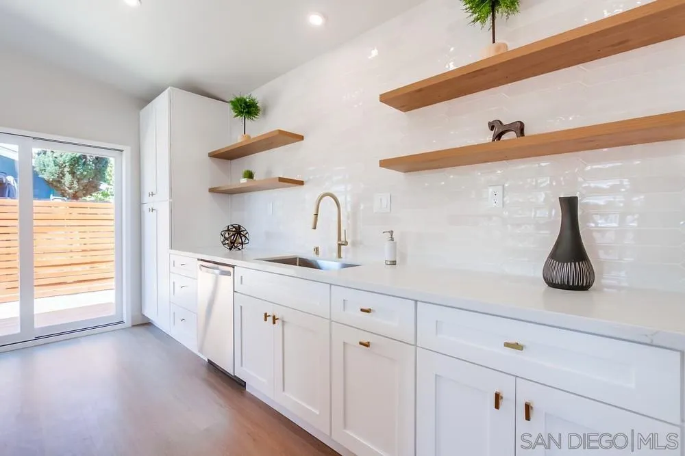 122 Lancer Avenue Oceanside, CA 92058 - Photo 13 of 67 a kitchen with sink a window and stainless steel appliances