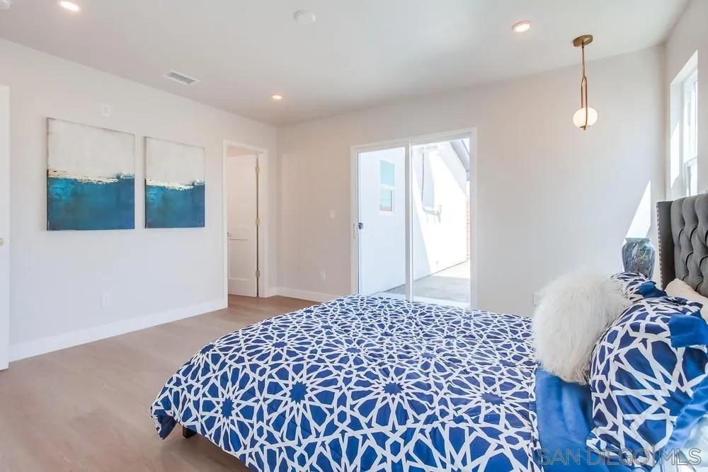 122 Lancer Avenue Oceanside, CA 92058 - Photo 23 of 67 a bedroom with a bed and a mirror
