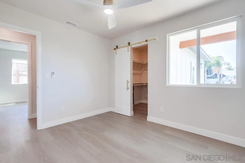 122 Lancer Avenue Oceanside, CA 92058 - Photo 30 of 67 an empty room with a window and wooden floor