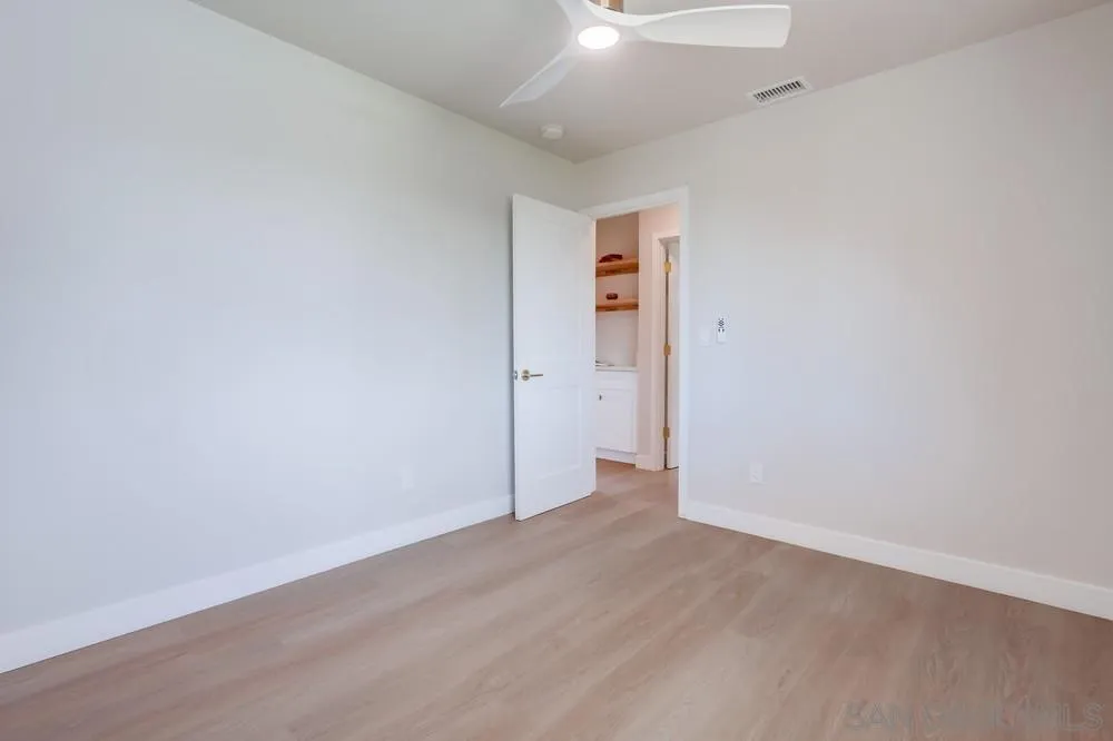 122 Lancer Avenue Oceanside, CA 92058 - Photo 31 of 67 an empty room with wooden floor and windows