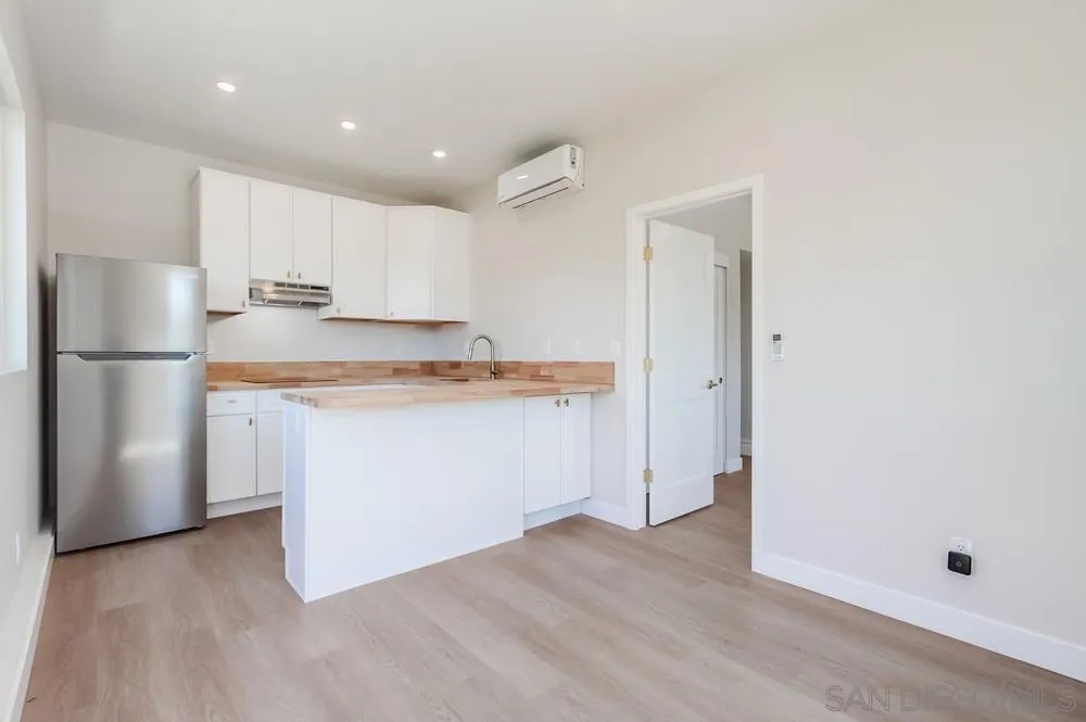 122 Lancer Avenue Oceanside, CA 92058 - Photo 34 of 67 a kitchen with stainless steel appliances granite countertop a refrigerator sink and white cabinets