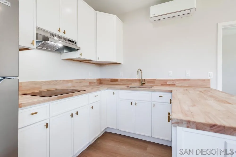 122 Lancer Avenue Oceanside, CA 92058 - Photo 36 of 67 a kitchen with granite countertop white cabinets and a sink