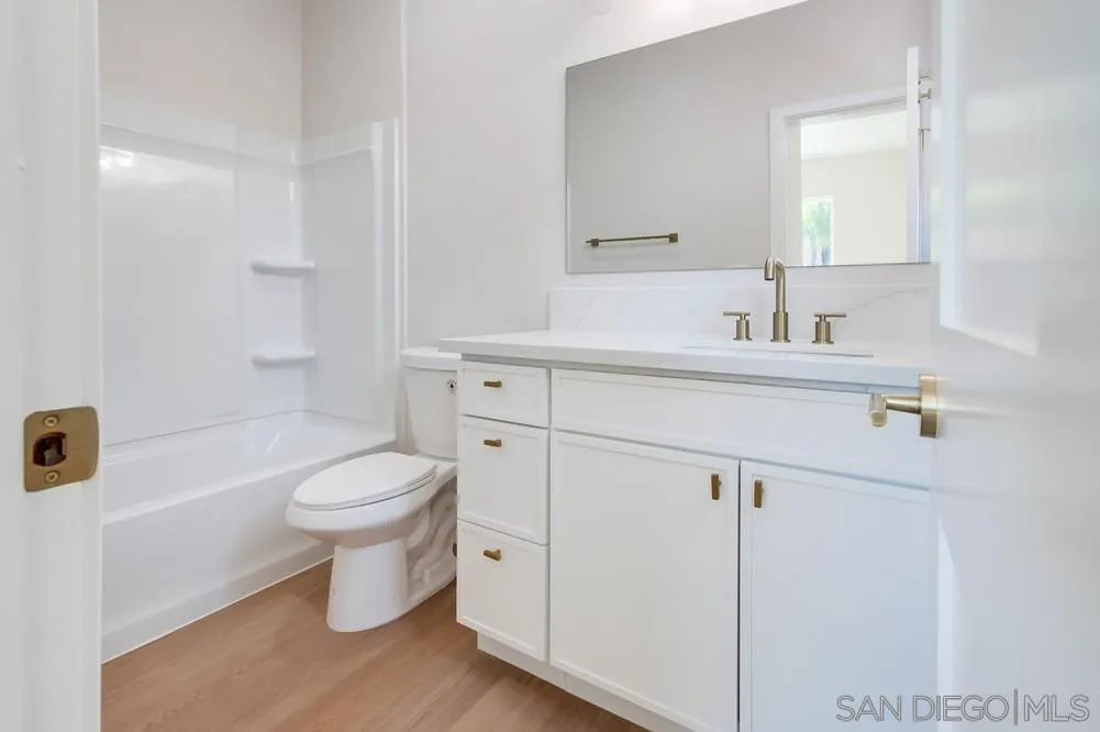 122 Lancer Avenue Oceanside, CA 92058 - Photo 43 of 67 a bathroom with a toilet sink a mirror and vanity