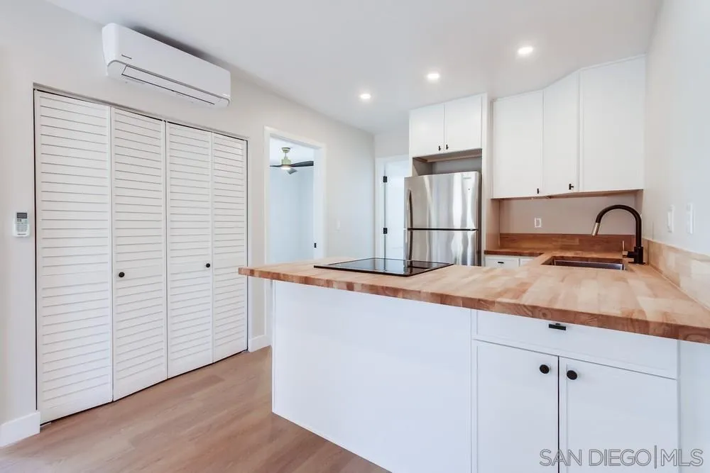 122 Lancer Avenue Oceanside, CA 92058 - Photo 51 of 67 a kitchen with stainless steel appliances granite countertop a sink and a refrigerator