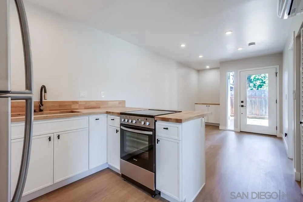 122 Lancer Avenue Oceanside, CA 92058 - Photo 53 of 67 a view of a kitchen with a stove wooden floor and a sink