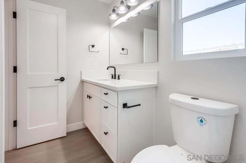 122 Lancer Avenue Oceanside, CA 92058 - Photo 61 of 67 a bathroom with a sink a toilet a mirror and shower