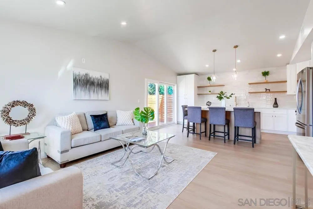 122 Lancer Avenue Oceanside, CA 92058 - Photo 8 of 67 a living room with furniture and a dining table with kitchen view