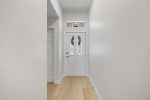 a view of a hallway with wooden floor