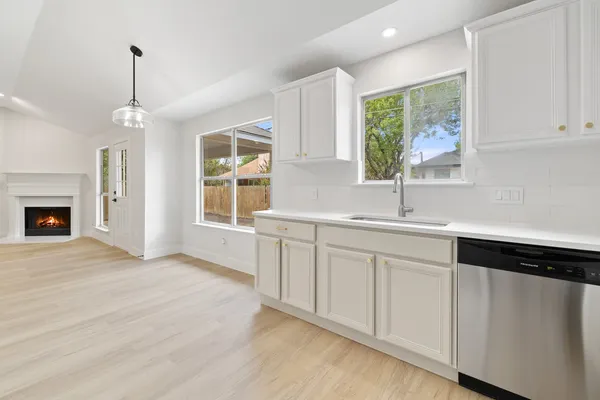 a kitchen with a sink cabinets and window