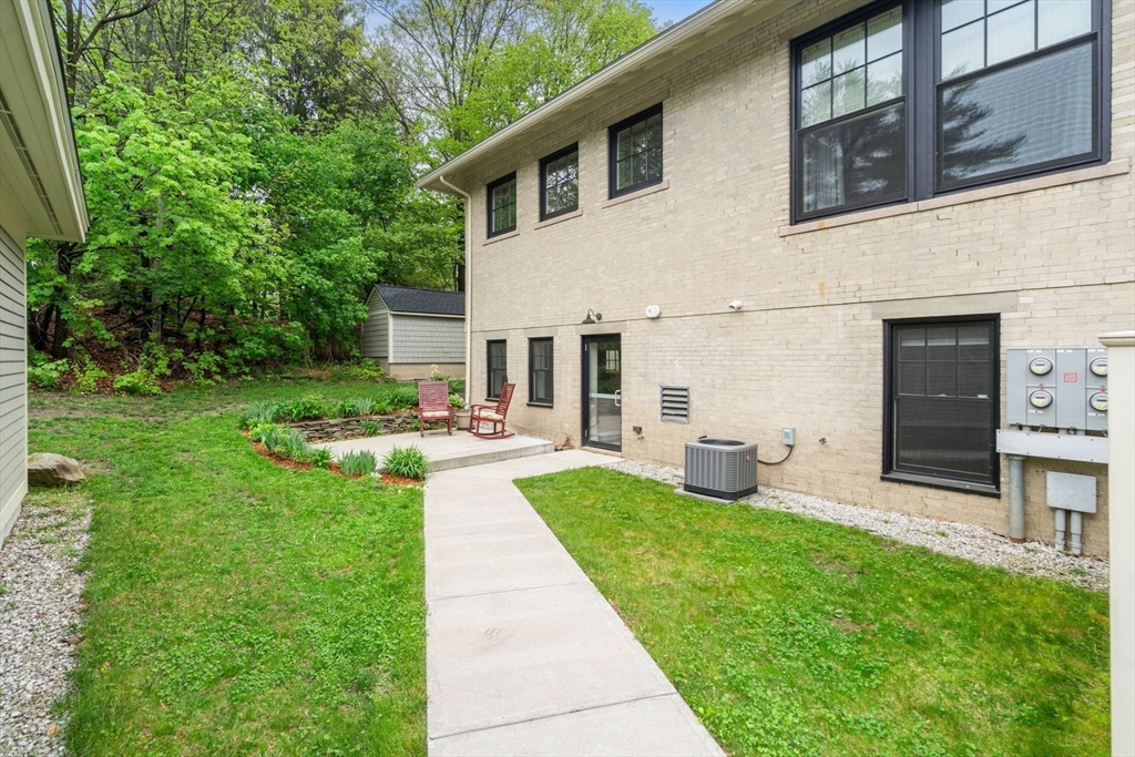 73 Pepperell Road, Unit C Groton, MA 01450 - Photo 3 of 35 a view of a patio with couches chairs potted plants and big yard