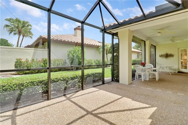 a view of a porch with furniture and garden