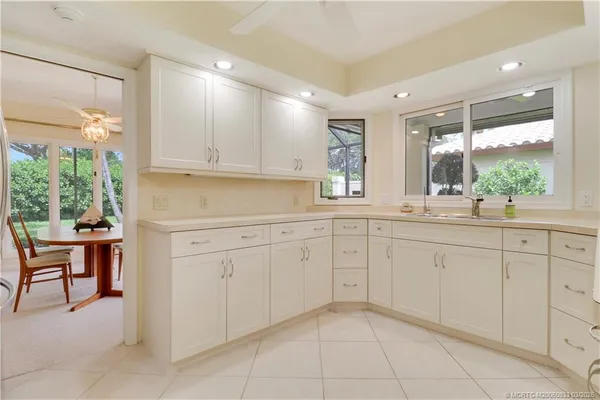a kitchen with cabinets appliances and a large window