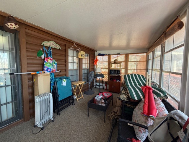 2795 East 28th Road Marseilles, IL 61341 - Photo 25 of 74 a living room with furniture a floor to ceiling window and a flat screen tv