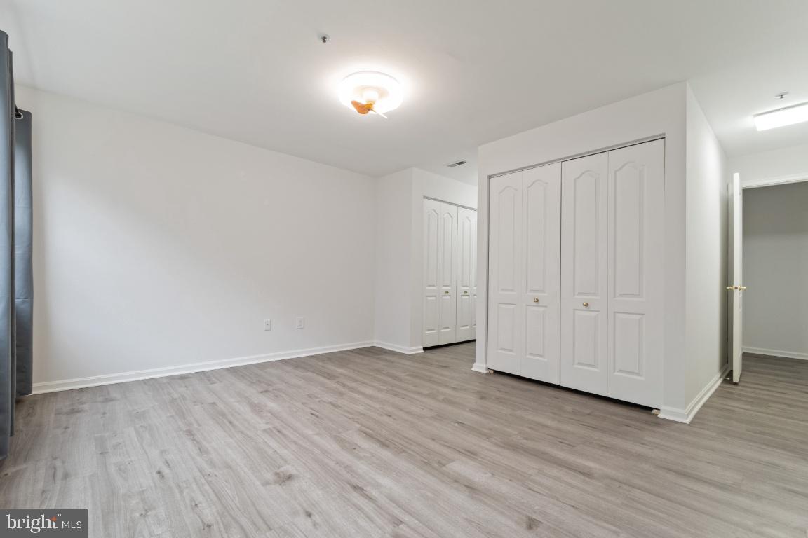 8573 Falls Run Road, Unit E Ellicott City, MD 21043 - Photo 17 of 21 a view of an empty room with wooden floor