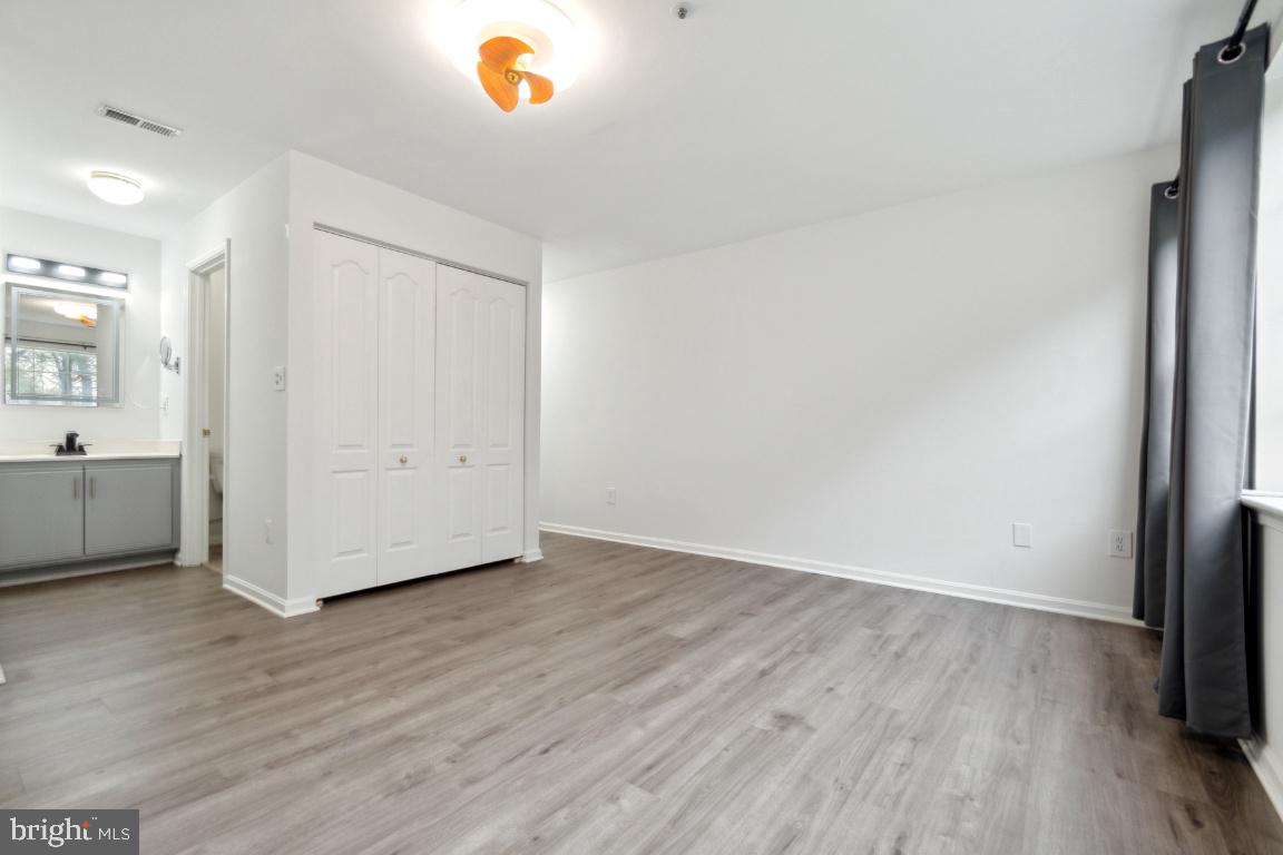 8573 Falls Run Road, Unit E Ellicott City, MD 21043 - Photo 18 of 21 a view of an empty room and wooden floor