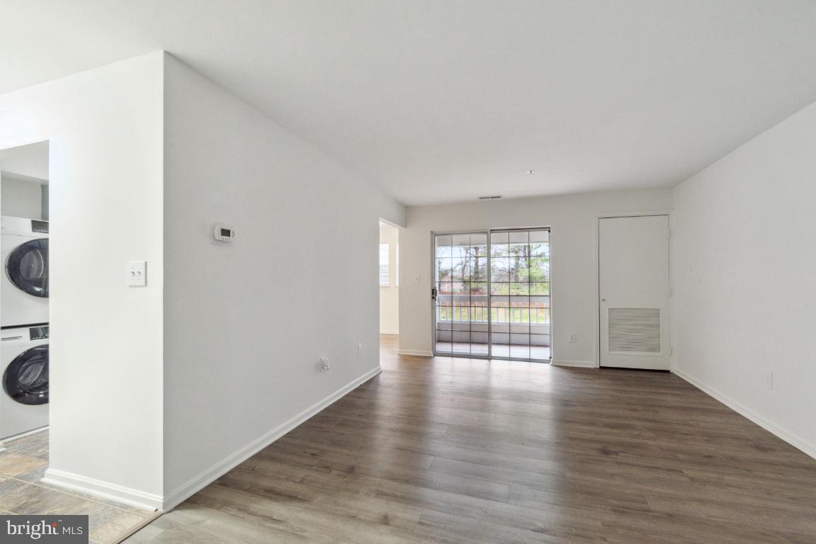 8573 Falls Run Road, Unit E Ellicott City, MD 21043 - Photo 9 of 21 an empty room with wooden floor and windows