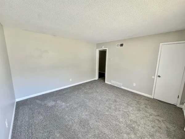 a view of an empty room and entryway