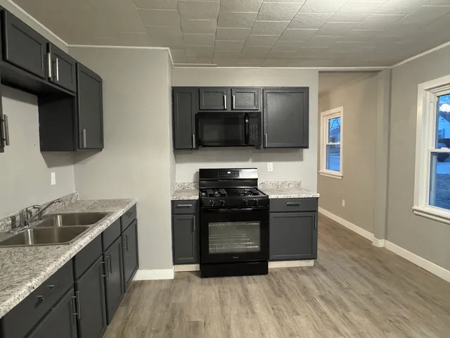 a kitchen with a stove and a sink