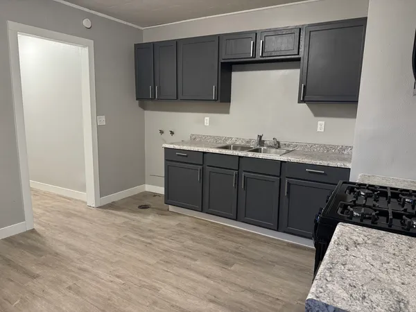 a kitchen with stainless steel appliances granite countertop a sink stove and microwave