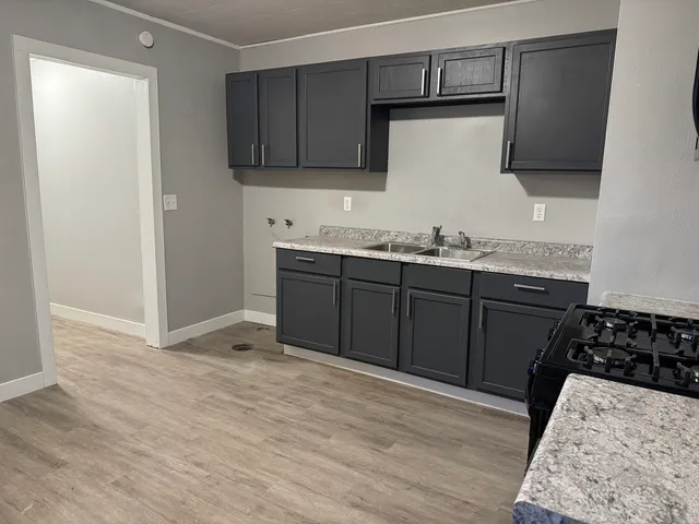 a kitchen with stainless steel appliances granite countertop a sink stove and microwave