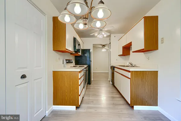 a large kitchen with stainless steel appliances granite countertop a stove a sink and a microwave