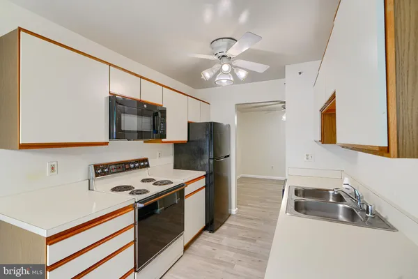 a kitchen with stainless steel appliances a sink stove and refrigerator