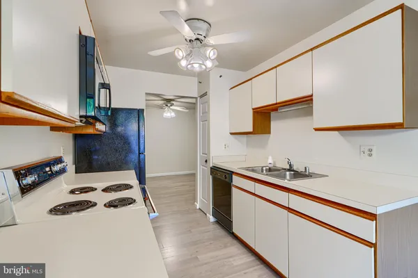 a kitchen with a sink a stove and cabinets