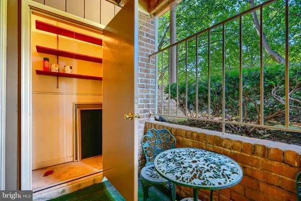 a view of a balcony with a table and chairs