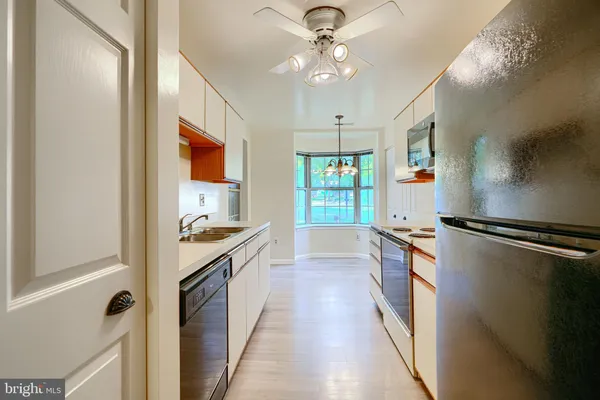 a view of a kitchen with a sink cabinets and a window