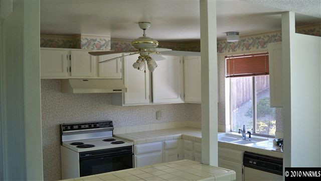 3545 Bryan Street Reno, NV 89503 - Photo 3 of 9 a kitchen with a refrigerator and a sink