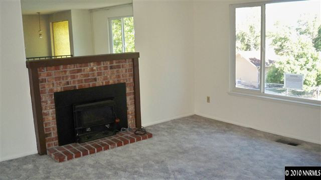 3545 Bryan Street Reno, NV 89503 - Photo 4 of 9 a view of an empty room with a fireplace and a window