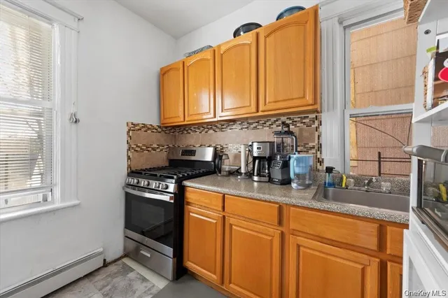 a kitchen with stainless steel appliances granite countertop a sink a stove and a microwave