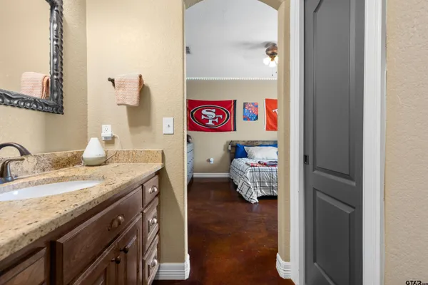 a bedroom with a bed and a flat screen tv