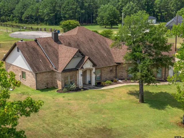a view of living room kitchen island stainless steel appliances wooden floor and living room view