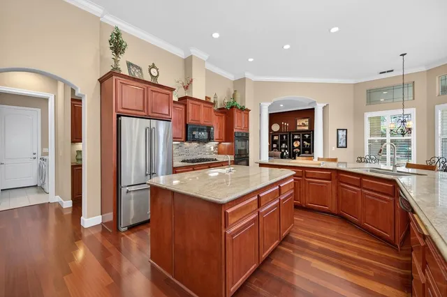a living room with furniture fireplace and potted plants