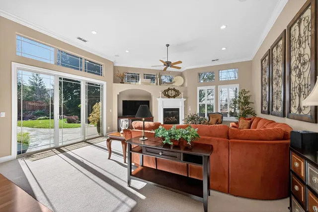 a bedroom with a large bed couch and windows