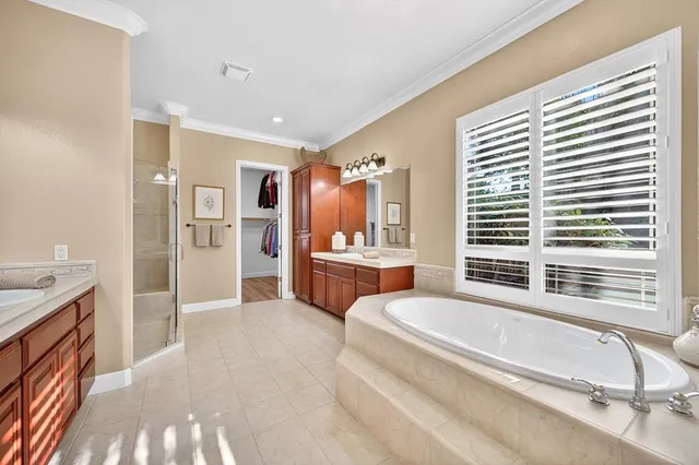 a bathroom with a granite countertop sink a large mirror and a shower