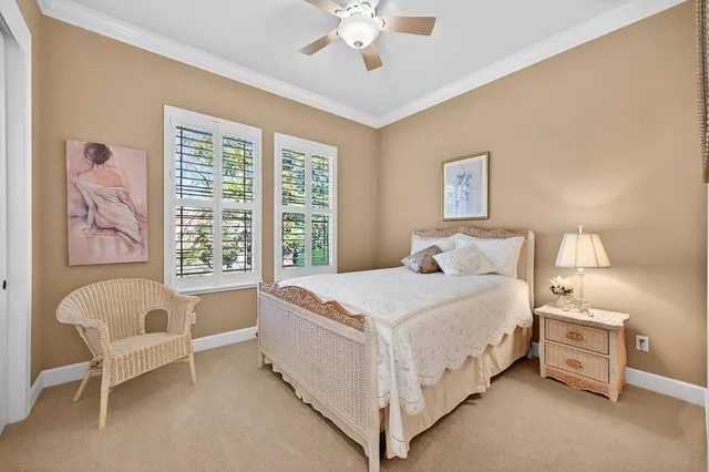 a bathroom with a granite countertop sink a toilet a large mirror and shower