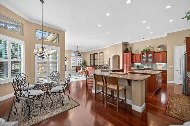 a kitchen with stainless steel appliances granite countertop a sink and a stove