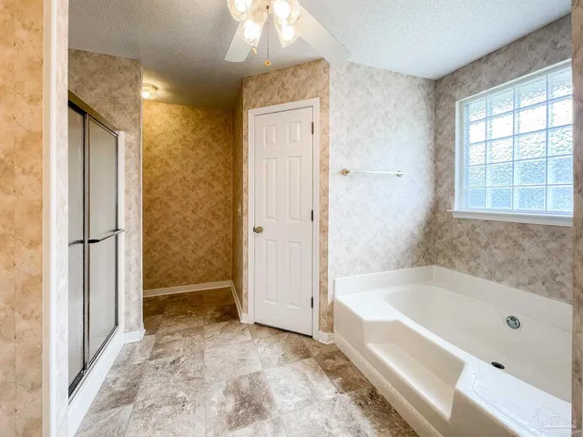 a bathroom with a bathtub and a shower