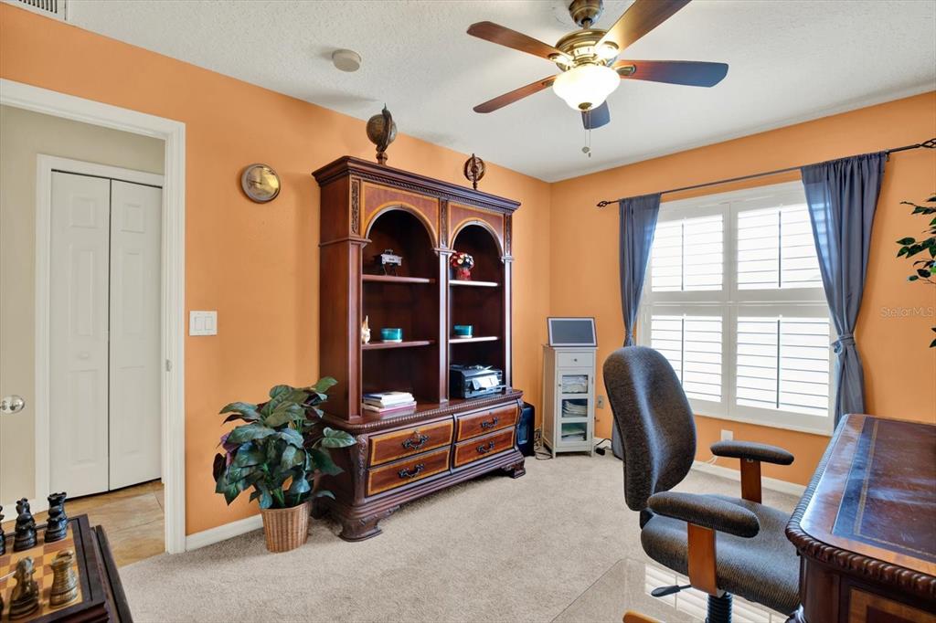 2021 Meadow Rue Court Trinity, FL 34655 - Photo 21 of 41 a view of a workspace with furniture and a window